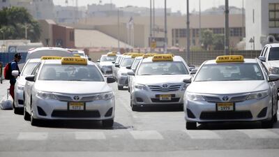 Taxis waiting for passengers on the first day of the Eid holiday near the Abu Dhabi bus terminal. Ravindranath K / The National