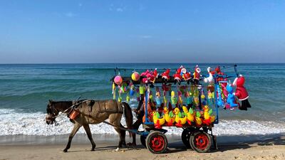 A Palestinian vendor sells toys at the beach in Gaza City. Reuters