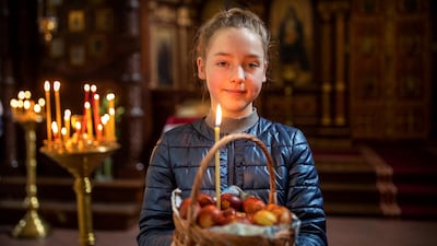 Marija Balciul, 10, poses with Easter eggs after a cake and Easter egg blessing ceremony at the Prechistensky, the Cathedral Palace in Vilnius, Lithuania on May 1, 2021. Orthodox Christians around the world celebrate Easter on May 2. AP Photo