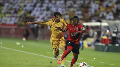 Al Wasl's Juan Culio, left, tries to steal the ball from Al Ahli's Ismaeel Al Hamadi during their Arabian Gulf League match on Thursday in Duabi. With the 2-1 victory, Al Ahli clinched the AGL title. Sarah Dea / The National