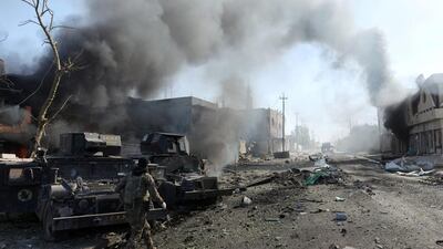 An Iraqi special forces soldier walks in front of humvees destroyed by an ISIL car bomb attack during clashes in Mosul, Iraq, November 19, 2016. REUTERS/Goran Tomasevic