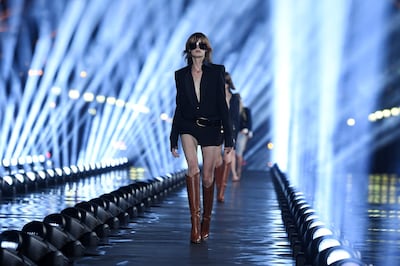 Models walk through spotlights at the Saint Laurent Spring/Summer 2020 show. Getty Images
