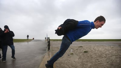 A man stand on the edge of a seawall during Storm Ciara in Harlingen which has brought unusually high winds across Europe with many countries cancelling national and international sport events. AFP