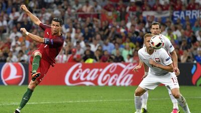 Cristiano Ronaldo, left, takes a shot at goal during extra time. Francisco Leong / AFP