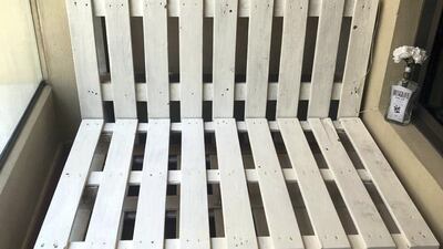 Using two pallets for the base and one for the back, they screwed them together using an electric drill to create the chair. Photo by Samantha Hall