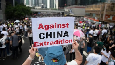 Protesters hold placards up. EPA