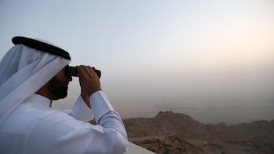 They first spot the new moon using a telescope before confirming it with the naked eye. EPA