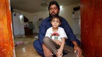 The victim's father Mukhtiar Ahmed Khudabaksh with his elder son Mustafah, 7, yesterday.
