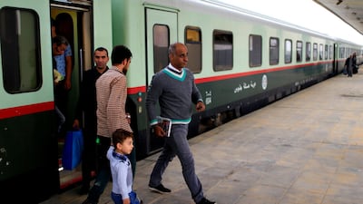 Passengers get off a train coming from Baghdad, as it arrives in Fallujah. Reuters