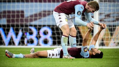 Aston Villa's Matt Targett (top) and his teammate Trezeguet at the end of the game. EPA