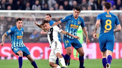Juventus' Paulo Dybala in action with Atletico Madrid's Rodri and Jose Gimenez. AFP