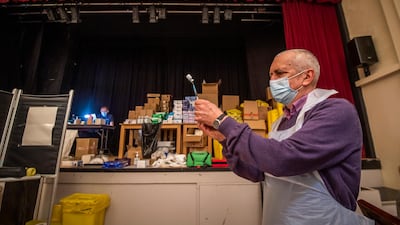 A vaccinator draws-up the vaccine into a syringe at Thornton Little Theatre near Blackpool, north-west England which is being used as a vaccination centre. Getty Images