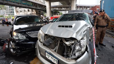 A Thai police officer inspects damaged cars. EPA