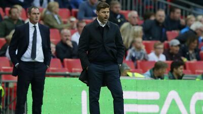 Tottenham Hotspur manager Mauricio Pochettino, right, and Swansea manager Paul Clement, left, had contrasting emotions after the draw. Tim Ireland / AP Photo