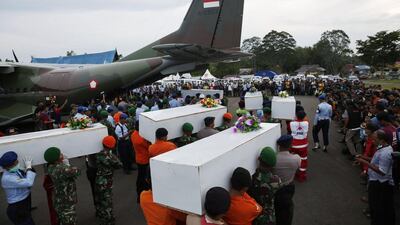 Caskets containing the remains of AirAsia QZ8501 passengers recovered from the sea are carried to a military transport plane at the airport in Pangkalan Bun, Central Kalimantan, on January 2, 2015. / Reuters