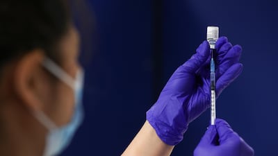 A healthcare worker fills a syringe with a dose of the Pfizer-BioNTech coronavirus disease (COVID-19) vaccine at the Newcastle Racecourse vaccination centre, in Newcastle upon Tyne, Britain. Reuters