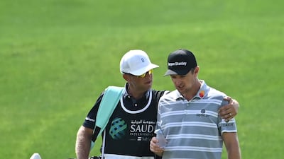 England's Justin Rose and his caddie walking down the 9th fairway. Rose carded an opening round 68. Getty