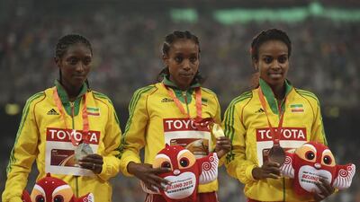 Ethiopia's medallists pose with their medals on the podium during the 2015 IAAF World Championships 2015. Greg Baker / AFP