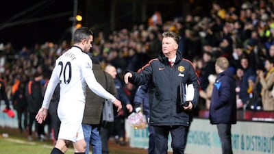 Manchester United striker Robin van Persie, left, trudges off the pitch after his side's goalless draw at Cambridge United in the FA Cup fourth round. Kieran Galvin/EPA