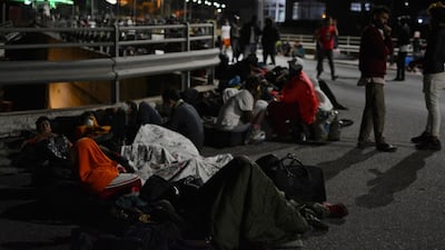 Refugees and migrants gather on a bridge as fire burns at the Moria refugee camp on the northeastern Aegean island of Lesbos, Greece. AP Photo