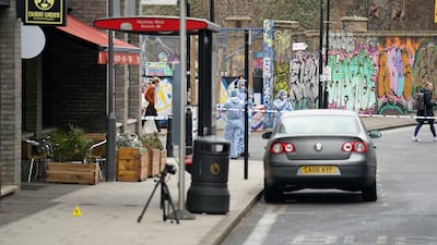 Police forensics officers at the scene where two people were stabbed, near White Post Lane, in east London. PA