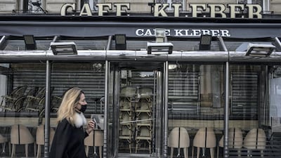 A woman walks past a closed cafe in Paris, France, in November. Eurozone GDP contracted 6.6% last year on 2019, as the region was hammered by the pandemic. Getty Images