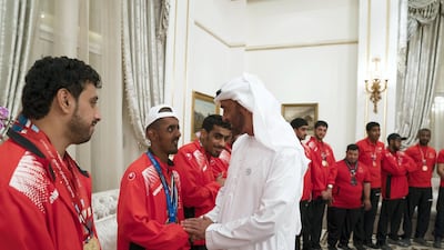 Sheikh Mohammed bin Zayed Al Nahyan, Crown Prince of Abu Dhabi and Deputy Supreme Commander of the UAE Armed Forces (R), greets a member of the UAE Special Olympics team, during a Sea Palace barza. Mohamed Al Hammadi / Crown Prince Court - Abu Dhabi