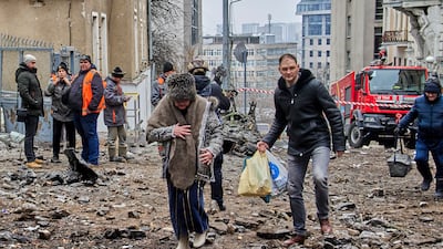Locals evacuate from a damaged residential building following a missile strike, in Kharkiv, northeastern Ukraine. EPA