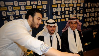 Miralem Pjanic and Paulo Dybala take a pic with a fan.