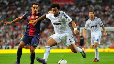 Marcelo duels for the ball with Xavi of Barcelona as Real win the Super Cup in 2012. Getty