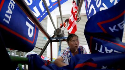A Chinese worker makes flags for US President Donald Trump's 'Keep America Great!' 2020 re-election campaign in Fuyang, Anhui province, China. Aly Song / Reuters