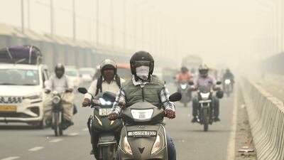 Traffic moves on a road enveloped by fog and smog in New Delhi, India. AP