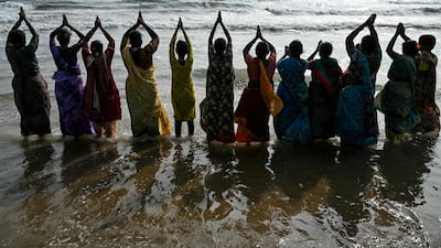 Women gather to pray for the victims of the 2004 Indian Ocean tsunami at Pattinapakkam beach in Chennai, south-east India. AFP