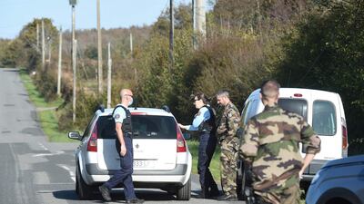French gendarmes stand guard on a road near Bellebranche forest in Saint-Brice, western France, on Tuesday during the search for the girl. AFP