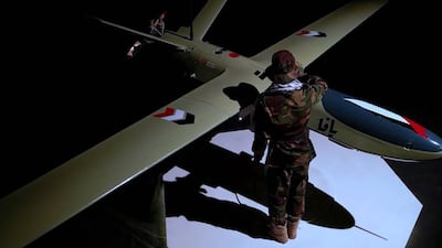 A rebel fighter stands next to a drone. EPA