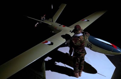 A fighter standing next to a drone in Sanaa. EPA