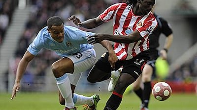 Kenwyne Jones, right, scorer of Sunderland's opener, tangles with City's Vincent Kompany.
