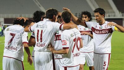 Al Wahda players celebrate with Sebastian Tagliabue, No 11, who scored all four goals in his team's 4-1 Arabian Gulf League defeat of Ajman at Al Nahyan Stadium in Abu Dhabi on April 11, 2014. Courtesy Al Ittihad