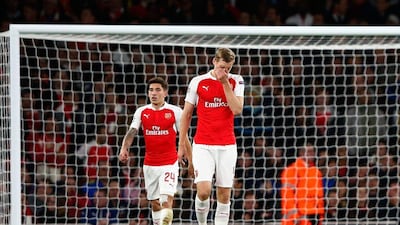Per Mertesacker of Arsenal reacts after the third Olympiakos goal in his team's Champions League defeat on Tuesday night. Shaun Botterill / Getty Images / September 29, 2015