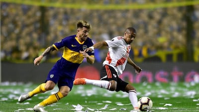 Julio Buffarini of Boca Juniors challenges Nicolas De La Cruz of River Plate, right, during a Copa Libertadores semifinal second leg soccer match at La Bombonera stadium in Buenos Aires, Argentina, Tuesday, Oct. 22, 2019. (AP Photo/Gustavo Garello)