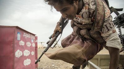 A member of Yemeni Tihama forces jumps to take cover during clashes with Houthi fighters, June 2, 2018. Asmaa Waguih for The National