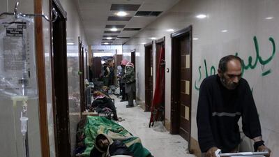 Wounded Syrians lying on the floor of the last functioning hospital as people wait to be evacuated on December 18, 2016 in the last rebel-held pocket of Syria’s Aleppo. More than 1,000 people were evacuated early on Monday after hours of delay. Karam Al Masri/AFP