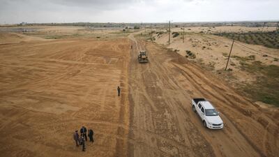 Palestinian municipality workers and Health Ministry personnel stand at the construction site of a field hospital to house coronavirus patients in Rafah in the southern Gaza strip. AFP