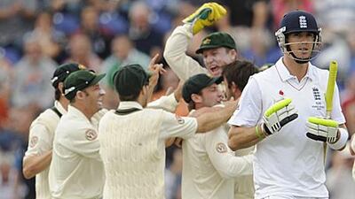 Kevin Pietersen, right, walks after in front of the celebrating Australians after being bowled by the seamer Ben Hilfenhaus.