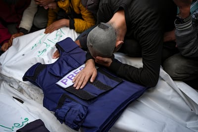 A relative mourns over the body of Ayman Al Jadi, one of the five Palestinian journalists who were killed by an Israeli air strike in Gaza city. AP Photo