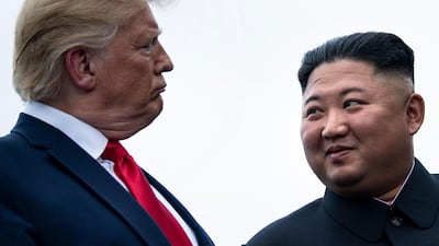North Korea's leader Kim Jong-un talks to US President Donald Trump at a meeting on the border with South Korea on June 30, 2019. AFP