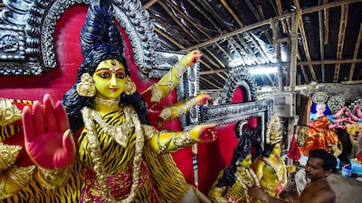 An artisan gives final touches to a clay idol of the Hindu deity Durga at a workshop in Allahabad. AFP