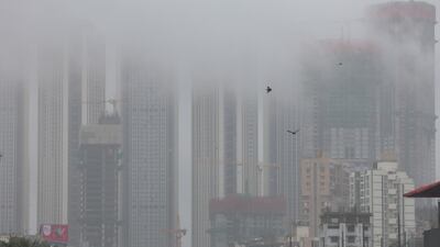 A high-rise building surrounded by fog during heavy rain in Mumbai. EPA