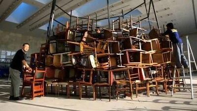 Japanese artist Tadashi Kawamata begins work on his sculptural installation entitled Chairs for Abu Dhabi yesterday at Manarat Al Saadiyat in Abu Dhabi. Ravindranath K / The National