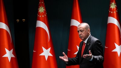 Turkish President Recep Tayyip Erdogan gestures and reacts as he arrives on stage to deliver a speech following a cabinet meeting in Ankara. AFP